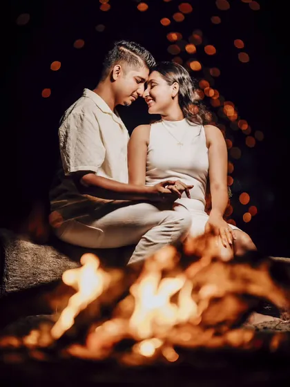 Eden and Snyder sharing a smile by the bonfire. The fire provides a warm, dynamic light source that makes for truly unique and romantic night portraits.