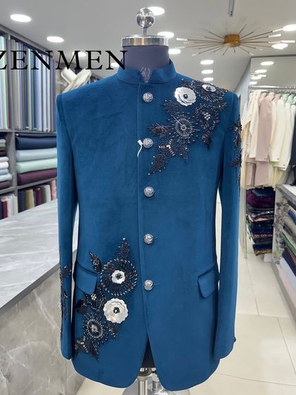 A stunning teal blue velvet Jodhpuri with 3D floral embellishments in black and white. This is a true work of art, combining bold color with intricate craftsmanship.