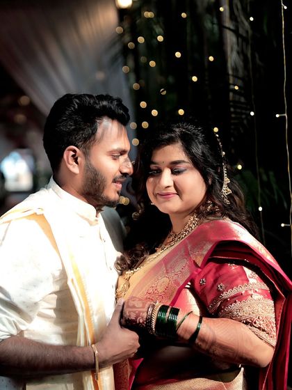 An intimate close-up of the couple against a backdrop of fairy lights. This photo focuses on the tender emotions and connection shared between the bride and groom during their wedding.