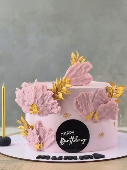 A lovely pink cake with abstract, textured petals and gold leaf accents, perfect for a mother's birthday or Mother's Day.