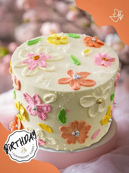 A lovely floral cake with hand-piped buttercream flowers in pastel shades. This design has a charming, rustic feel that is both beautiful and sweet.