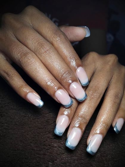 A delicate blend of soft pink and metallic blue. This is a beautiful and modern twist on the classic French manicure, with soft blue chrome tips.
