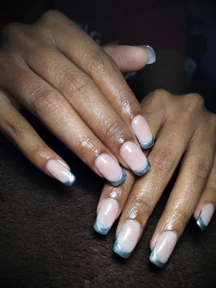 A delicate blend of soft pink and metallic blue. This is a beautiful and modern twist on the classic French manicure, with soft blue chrome tips.