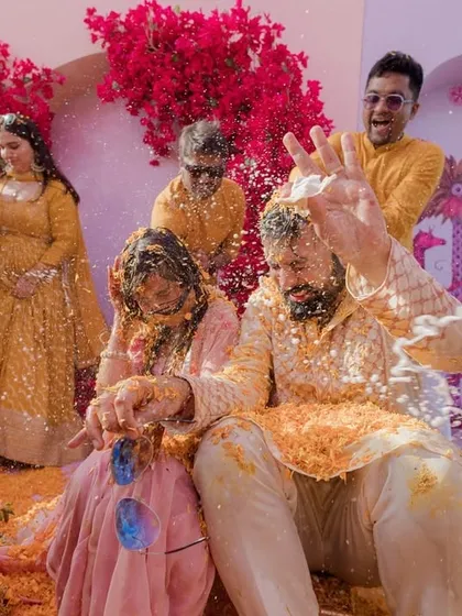 The groomsmen having a great time covering the couple in Haldi and other things.