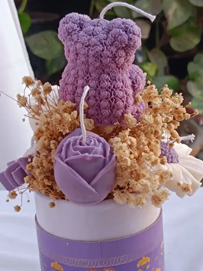 A close-up of the flowers in the purple bouquet candle.