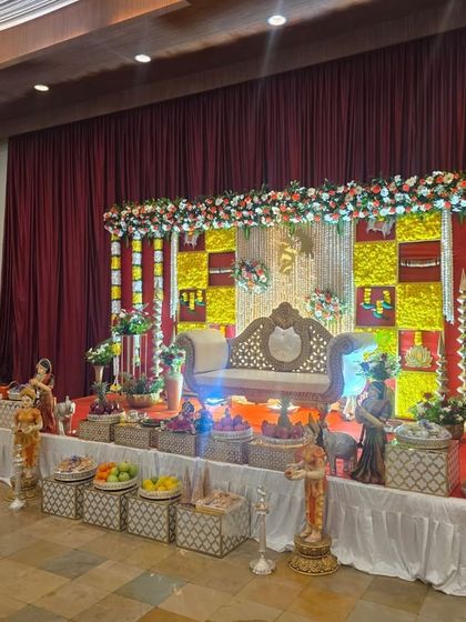 An angled view of the red and yellow checkered stage, showing the lighting and the full arrangement of offering baskets.