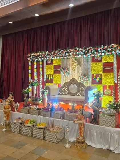An angled view of the red and yellow checkered stage, showing the lighting and the full arrangement of offering baskets.