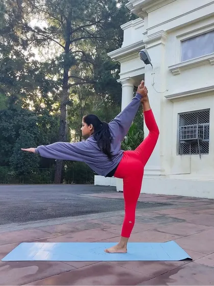 A classic Natarajasana (Lord of the Dance Pose) with a deep backbend. This pose builds balance and concentration while opening the shoulders and chest.