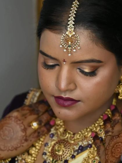 A moment of quiet contemplation. The bride's downward gaze shows off her beautiful eyeshadow and long lashes, part of the detailed eye makeup I create.
