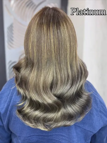 This platinum ash blonde is a true hair color inspiration. The cool, silvery tones are expertly blended for a high fashion, striking look.