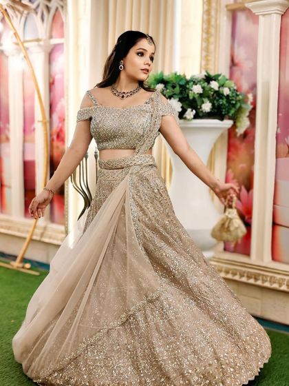 Another angle of the client in the champagne gold lehenga, showcasing its sparkle and elegance.