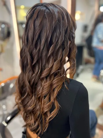A "Root Melt" is a technique where I blend the highlights into the natural root color for a seamless, low-maintenance grow-out.