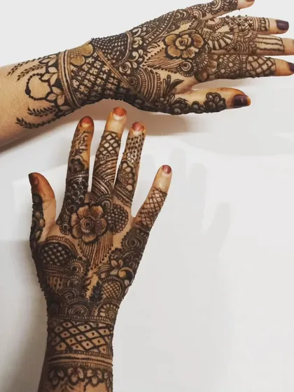 A showcase of two different hands with complementary designs. This is a great reference for clients who want to see different styles side-by-side.