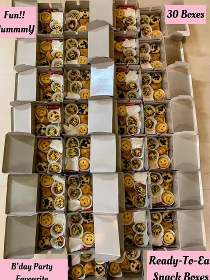 An aerial shot of 30 snack boxes ready for a birthday party.