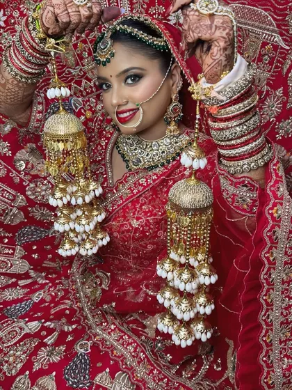 This classic bridal pose showcases the entire look, from the intricate jewelry to the flawless makeup. I ensure every bride feels like royalty.