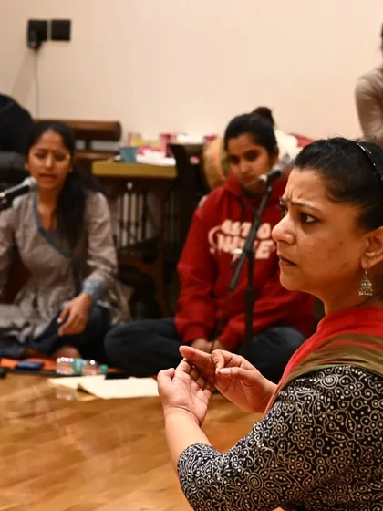 Guiding the vocalists during a music rehearsal for 'Songs of the Millstone'. The songs are the foundation of this piece, and their authentic and emotional rendering is paramount.
