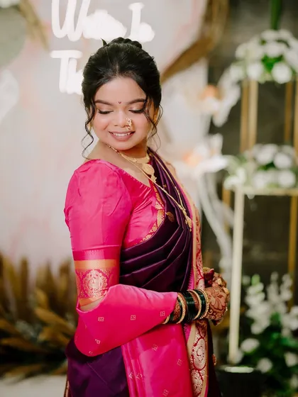 A close-up of the bride's soft makeup for her Vidhi ceremony, with gentle curls framing her face.