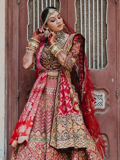 A moment of quiet grace. The bride adjusts her earring, a simple, elegant gesture captured beautifully.