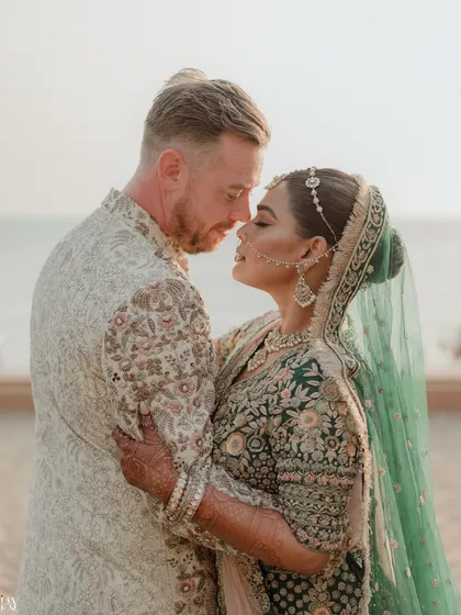 An intimate couple portrait from a beach wedding, capturing a quiet moment of connection against the serene backdrop of the sea. We specialize in finding these beautiful, personal moments amidst the celebration.