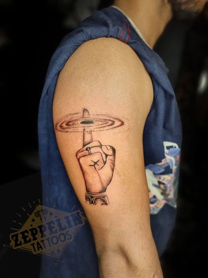 A depiction of the Sudarshan Chakra, the divine discus of Lord Vishnu, spinning on a finger. This piece symbolizes protection, righteousness, and divine power.