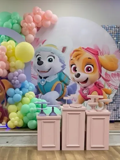 The full Paw Patrol stage setup, ready for the party. The pastel color palette offers a softer, more modern take on the popular cartoon theme.
