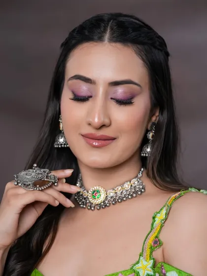 A closer look at the pink winged liner and shimmery purple eyeshadow. This is a creative and colorful eye look for someone who loves to experiment.