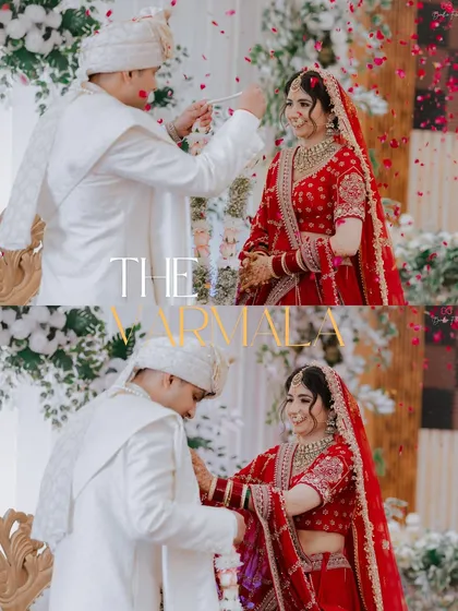 The Varmala ceremony, a moment of union and joy, captured with a focus on the couple's happy expressions and the beautiful floral decor.
