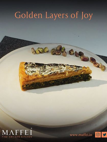 Golden layers of joy. Our classic baklava features crisp phyllo pastry, a rich nut filling, and a silver leaf garnish, offering a bite of pure, sweet tradition.