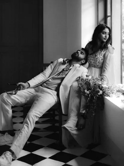 A moment of artistic repose. This black and white portrait of Midhun and Anjana by the window has a classic, cinematic feel, capturing a quiet, soulful connection.
