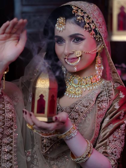 A beautiful portrait of the Khaliji bride, holding a lantern to create a warm, inviting glow.