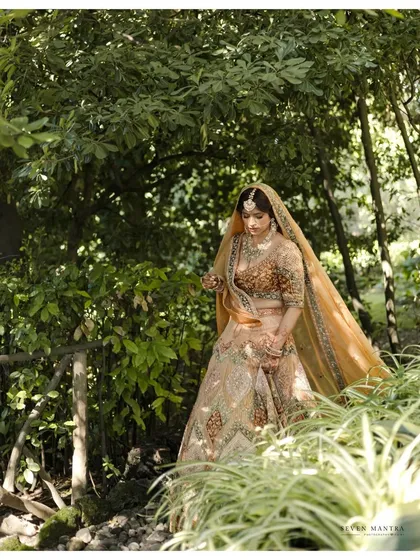 A bride in her natural element. I styled this portrait of the bride walking through a wooded path, the dappled sunlight filtering through the leaves and highlighting the rich colors of her Sabyasachi lehenga.