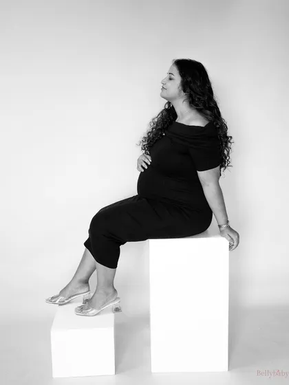 A classic and elegant black and white studio portrait. The clean lines and simple composition create a timeless image that focuses on her serene beauty.