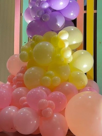 A close-up of the balloon clusters used in the rainbow theme. I carefully arrange different shades of pink, yellow, and purple to create a soft yet colorful look.