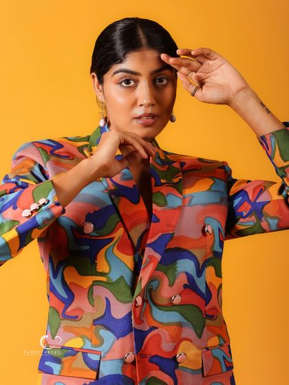 A close-up shot that frames the face beautifully. The hand gestures add a sense of movement and artistry to the portrait.