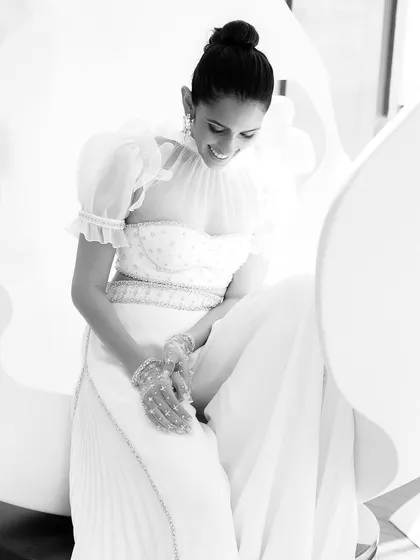 This white Sabina Bilenko outfit is all about moonlit elegance. The high-neck blouse with puff sleeves and pleated pants, paired with starry gloves, is a truly unique and couture look.