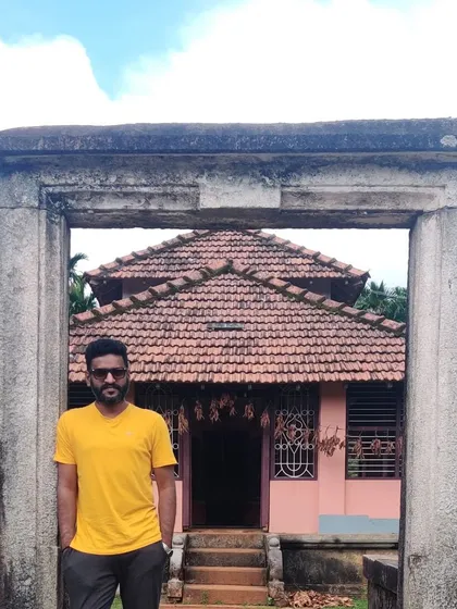 A trekker at the entrance of a traditional house or temple.