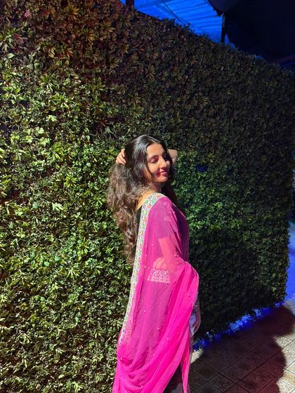 The flowing pink dupatta adds a beautiful touch of colour to the all-black outfit.