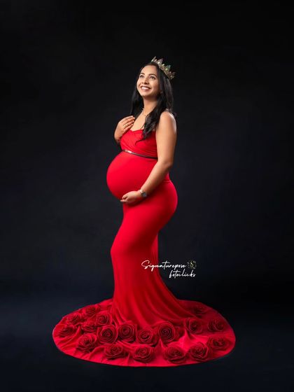 A classic, elegant portrait in a red gown with a rose-detailed train, perfect for a timeless look.