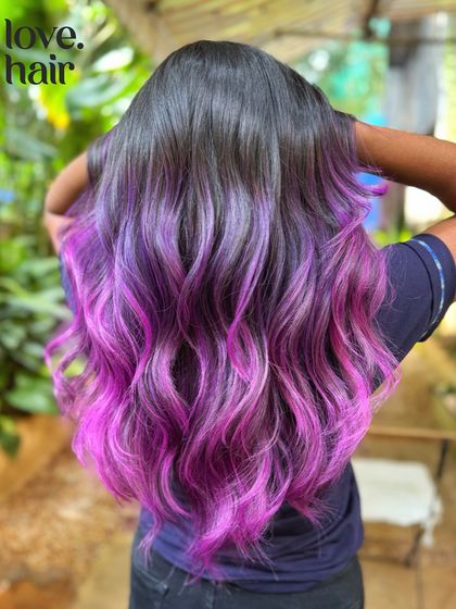 A close-up of the 'molly melt', showing the seamless transition from purple to pink on long, healthy-looking hair.
