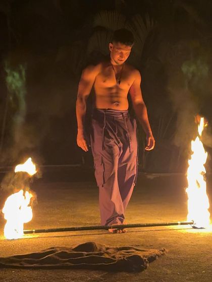 A moment of calm before a fire slacklining performance. Balancing on the line is hard enough, but adding a fire staff brings a whole new level of focus and intensity.