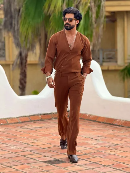 Experience effortless style with our Spice V-neck shirt and matching trouser co-ord set. This ensemble, shown here in a beautiful resort setting, is crafted for comfort and designed to make a confident statement.
