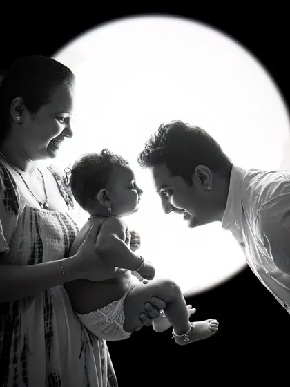 A black and white version of the backlit family portrait. The lack of color puts all the emphasis on the shapes, emotions, and the story being told.