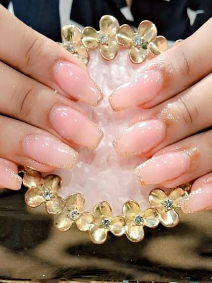 This client's natural nails were strengthened with gel and given a touch of glamour with a fine gold glitter outline.