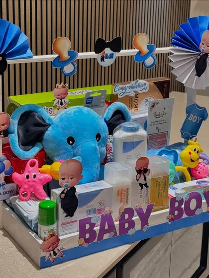 A slightly different angle of the blue-themed Boss Baby hamper, showing the variety of toys and baby care products included.
