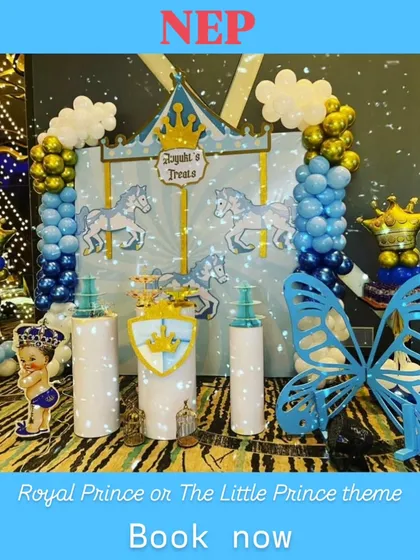 This royal-themed dessert station features a carousel backdrop, horse cutouts, and balloon columns topped with crowns, perfectly matching the little prince theme.