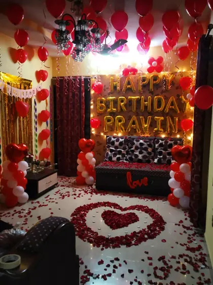 A full room view of the red and white surprise birthday decoration.