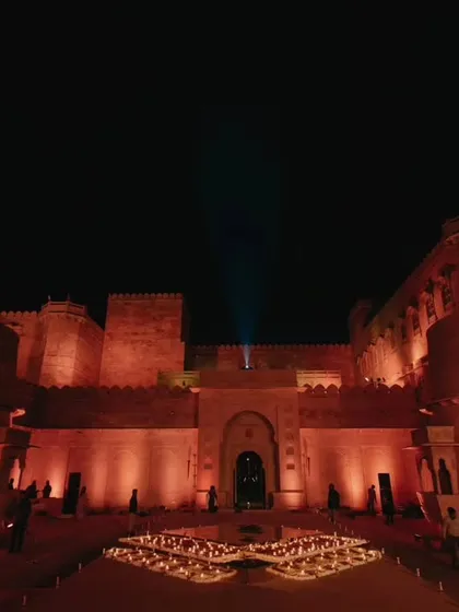 The magnificent Suryagarh palace illuminated at night, creating a dramatic and regal atmosphere. This is the kind of breathtaking venue we select for our destination weddings.