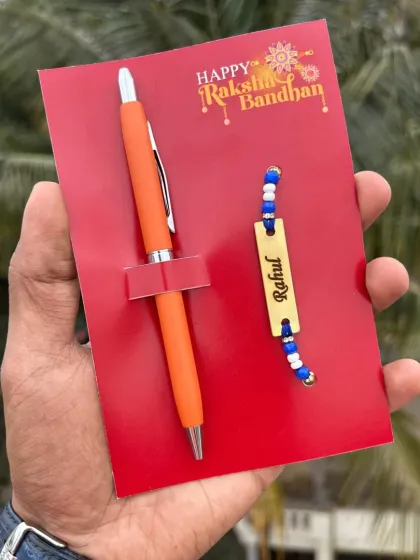 A simple and useful Rakhi gift. This combo pairs a personalized pen with a name-engraved rakhi, available in five bright colors.