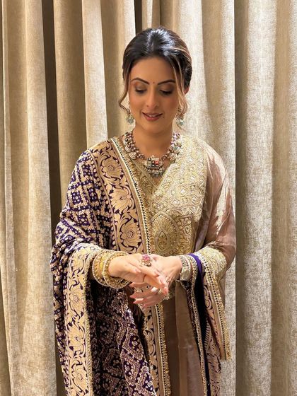 A full view of the client in her traditional attire, with her hair in an elegant updo. This style is perfect for any festive occasion, not just weddings.