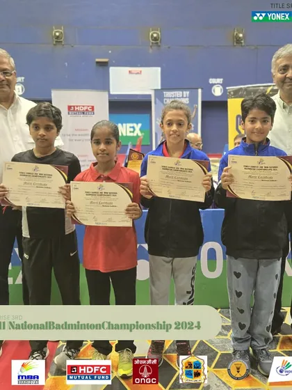 A group of young female winners on the podium at the Mini National Badminton Championship.